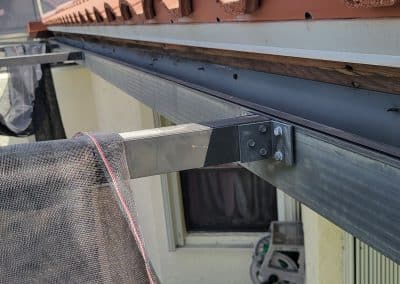 screws uncovered and fascia board without primer or paint scaled